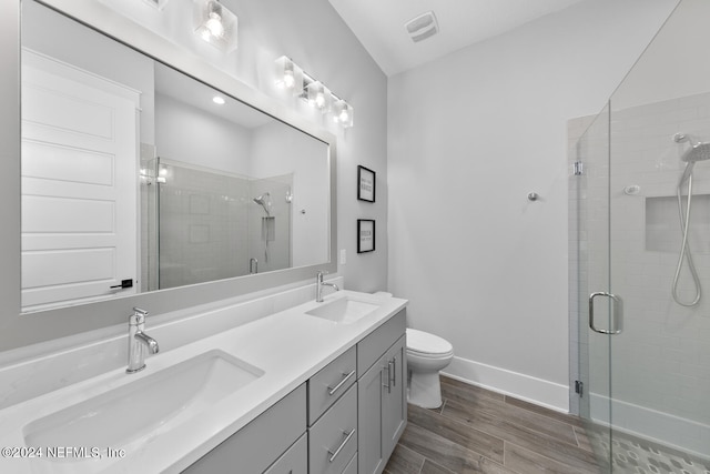 bathroom with vanity, toilet, and a shower with shower door