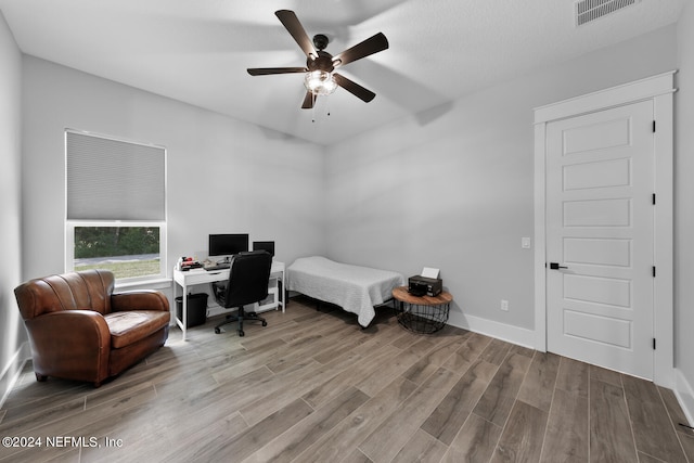 bedroom featuring ceiling fan and light hardwood / wood-style flooring