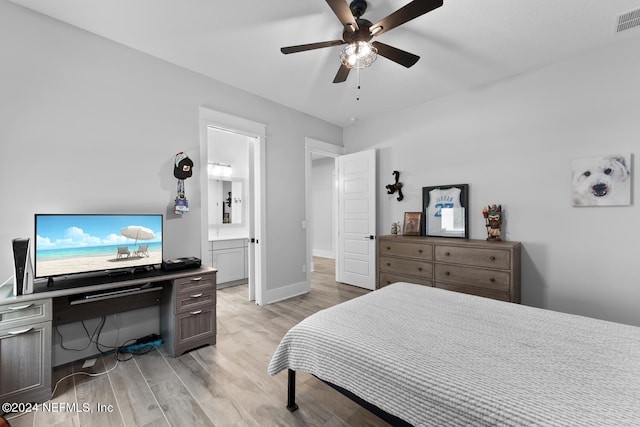 bedroom with ceiling fan, light wood-type flooring, and connected bathroom