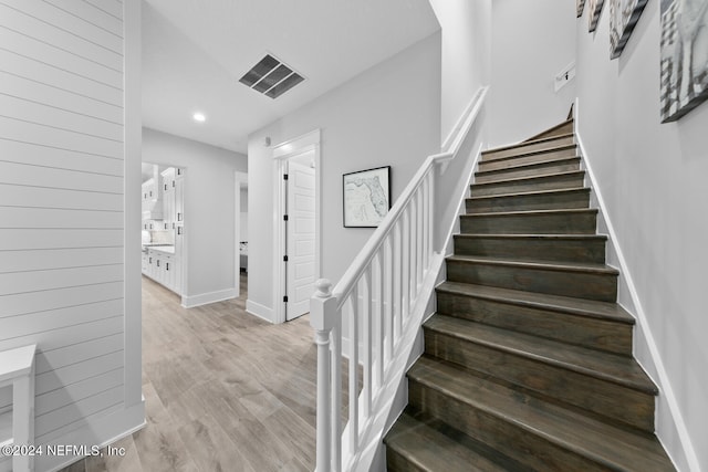 stairway featuring hardwood / wood-style flooring