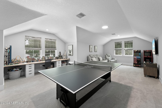 game room with light colored carpet, a textured ceiling, and vaulted ceiling