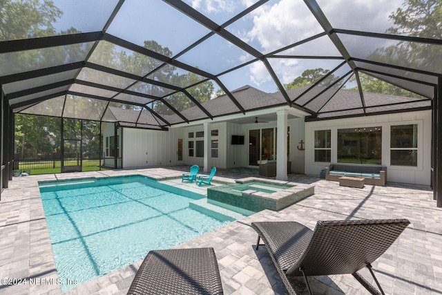 view of pool with an in ground hot tub, an outdoor hangout area, ceiling fan, glass enclosure, and a patio