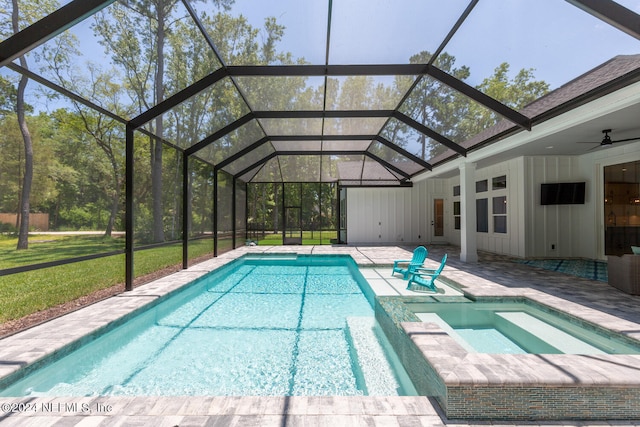 view of pool featuring an in ground hot tub, glass enclosure, ceiling fan, and a patio area