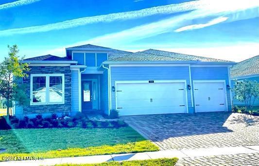 view of front of home featuring a garage and a front lawn