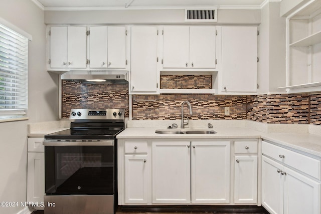 kitchen with backsplash, stainless steel electric stove, white cabinets, sink, and range hood