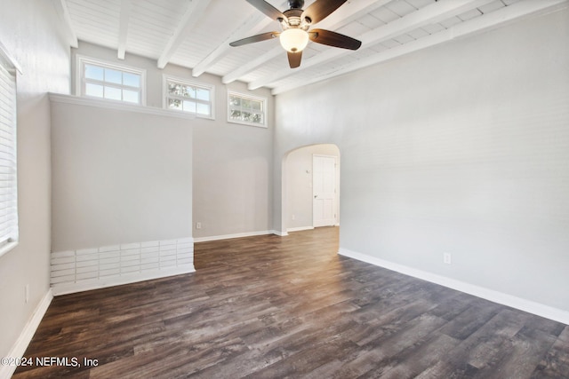 empty room with ceiling fan, dark wood-type flooring, beamed ceiling, a towering ceiling, and wood ceiling