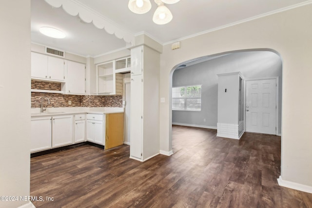 kitchen featuring sink, dark wood-type flooring, tasteful backsplash, white cabinets, and ornamental molding