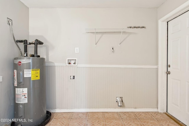 clothes washing area featuring electric water heater and hookup for a washing machine