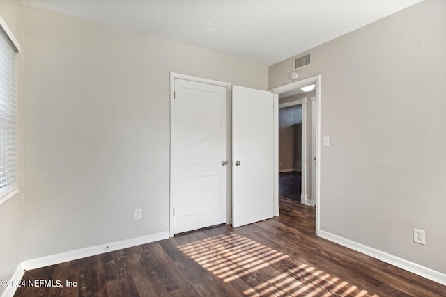 unfurnished bedroom featuring dark wood-type flooring