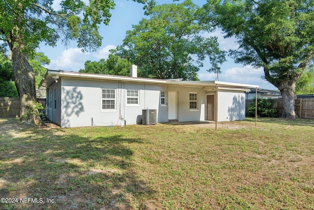 rear view of house with a lawn