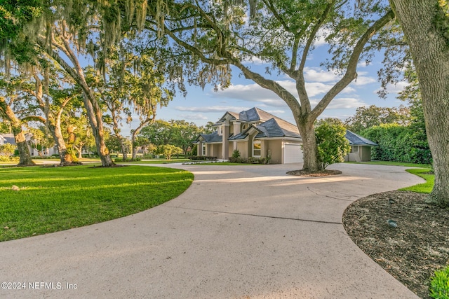 view of front of home with a front yard and a garage