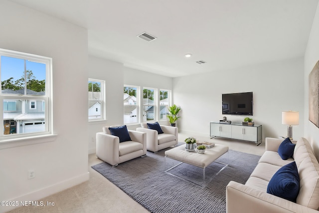 living room with baseboards, recessed lighting, visible vents, and light colored carpet