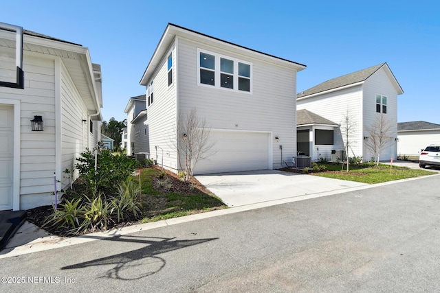 view of front of house featuring an attached garage, central AC, and concrete driveway