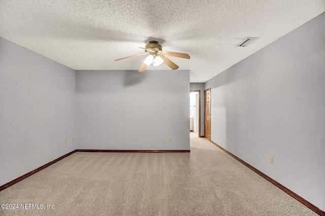 spare room with carpet, visible vents, and baseboards