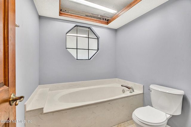 bathroom with tile patterned flooring, a garden tub, and toilet