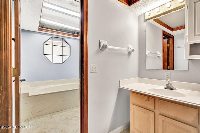 bathroom featuring a garden tub and vanity