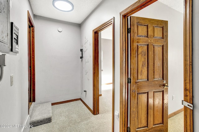 corridor with carpet and baseboards