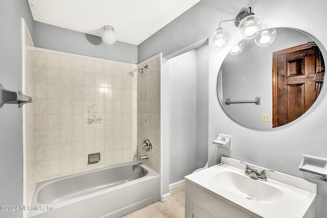 bathroom featuring a textured ceiling, vanity, baseboards, shower / washtub combination, and tile patterned floors