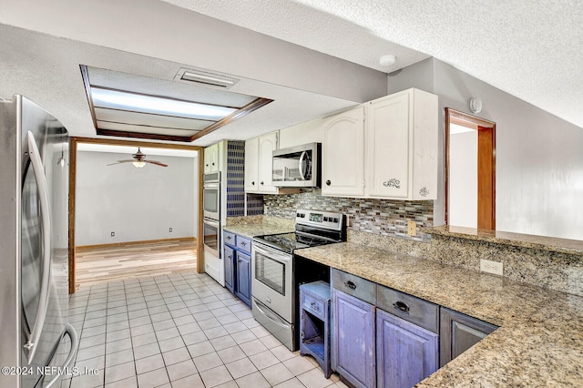 kitchen featuring a textured ceiling, stainless steel appliances, visible vents, white cabinets, and tasteful backsplash