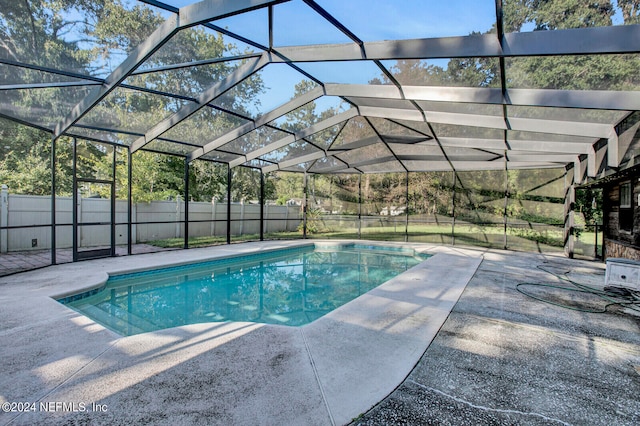 view of pool with a patio area, fence, a fenced in pool, and a lanai