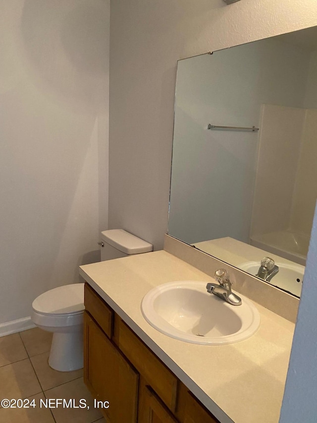 bathroom with tile patterned floors, vanity, and toilet