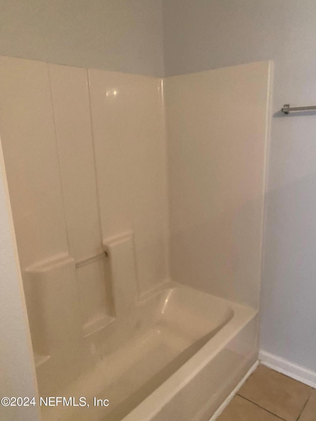 bathroom featuring tile patterned floors and independent shower and bath