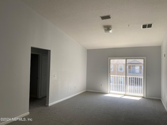 unfurnished room with carpet, a textured ceiling, and lofted ceiling