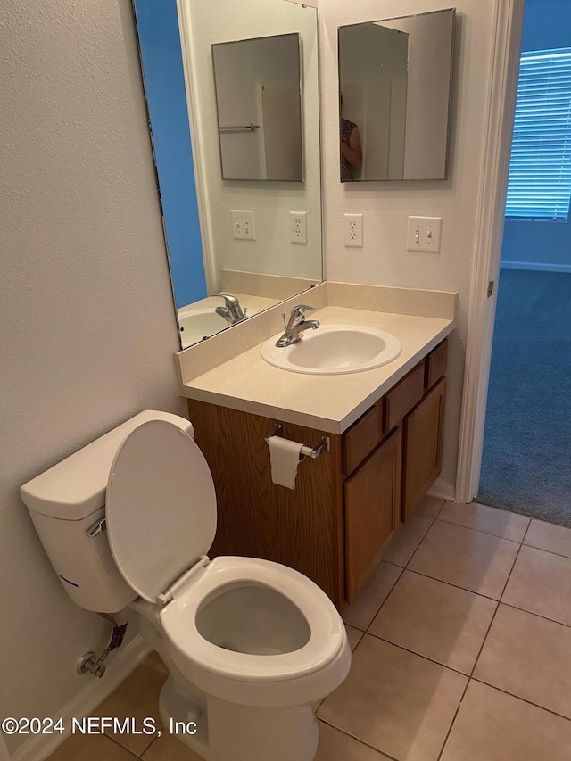 bathroom with tile patterned floors, vanity, and toilet