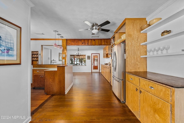 kitchen with ornamental molding, stainless steel fridge, ceiling fan with notable chandelier, dark hardwood / wood-style flooring, and decorative light fixtures