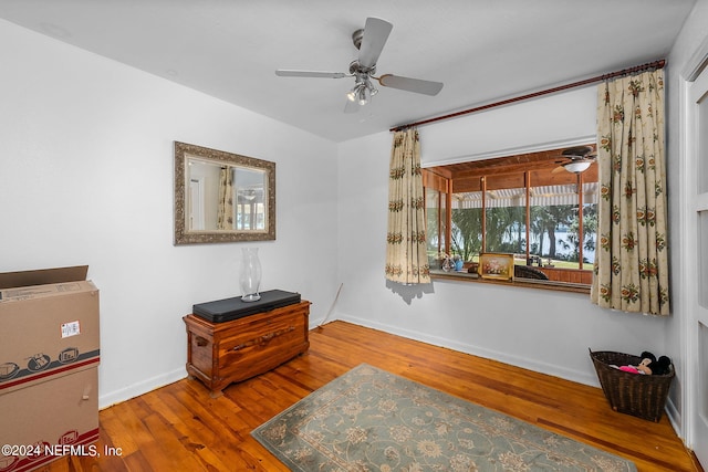 living area with ceiling fan and hardwood / wood-style floors