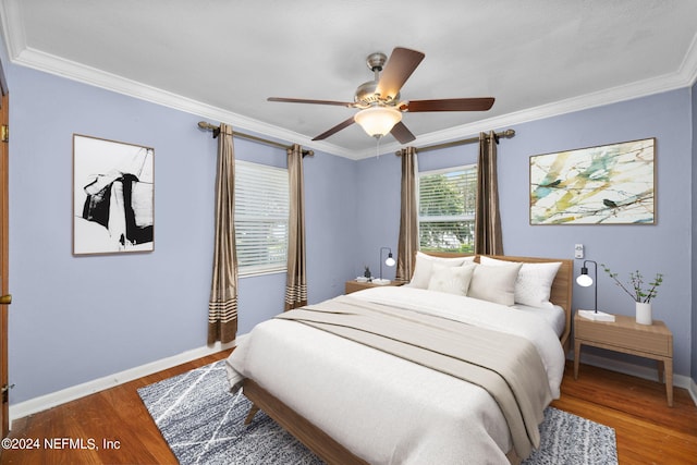 bedroom featuring hardwood / wood-style flooring, ornamental molding, and ceiling fan