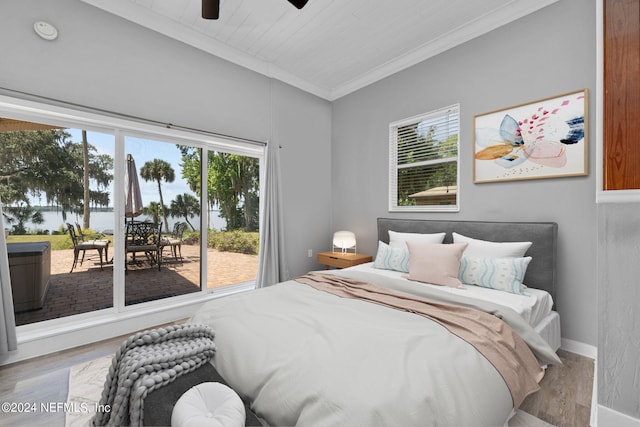 bedroom with hardwood / wood-style flooring, ornamental molding, and ceiling fan