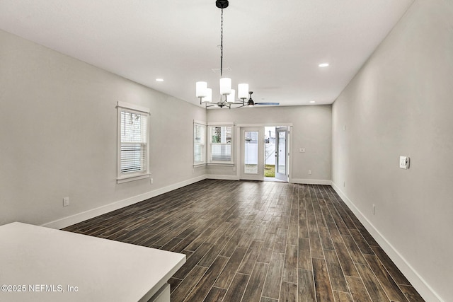 interior space featuring dark wood-type flooring and a chandelier