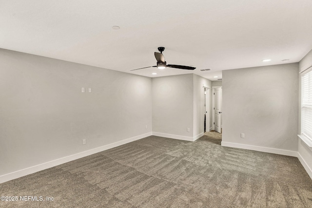 carpeted spare room featuring ceiling fan