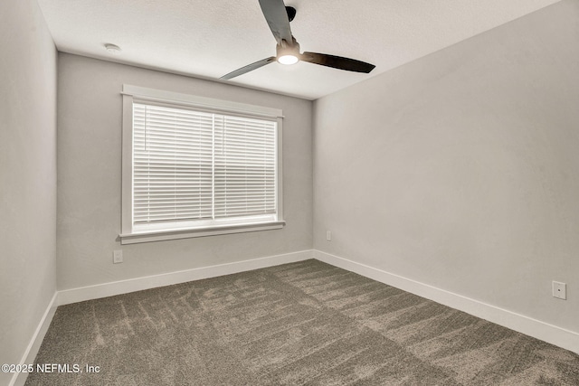 unfurnished room featuring dark carpet, a textured ceiling, and ceiling fan