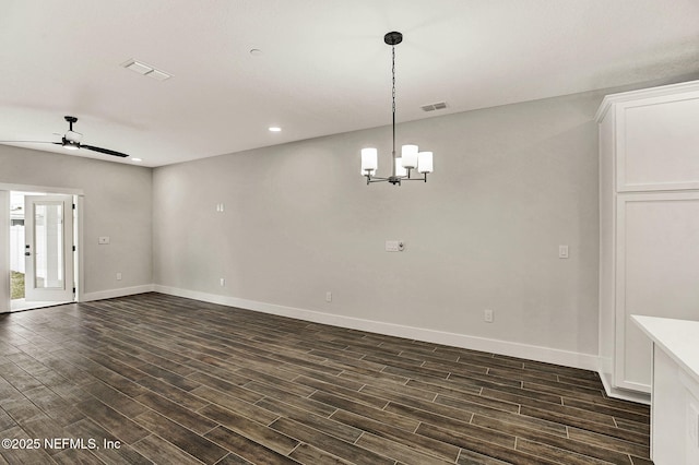 unfurnished room with dark wood-type flooring and ceiling fan with notable chandelier