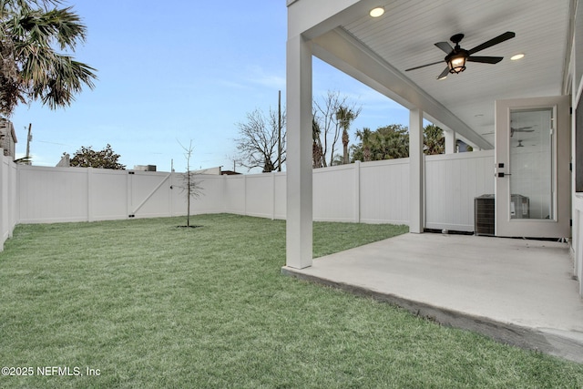 view of yard with cooling unit, ceiling fan, and a patio area