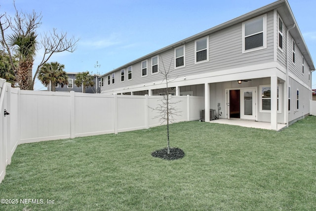 rear view of property with central AC, a yard, and a patio