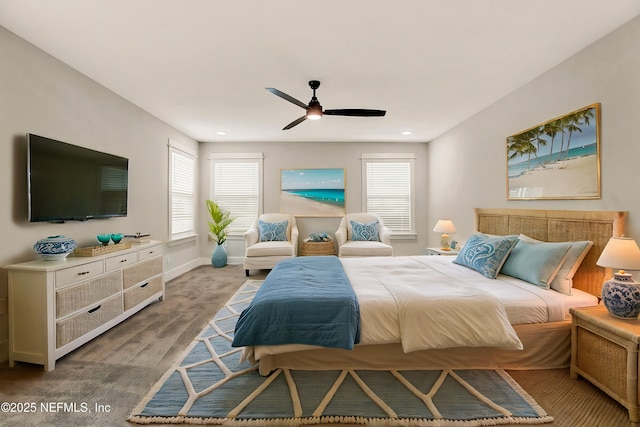 carpeted bedroom featuring multiple windows and ceiling fan