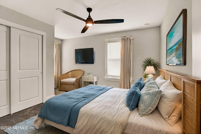 carpeted bedroom featuring ceiling fan and a closet