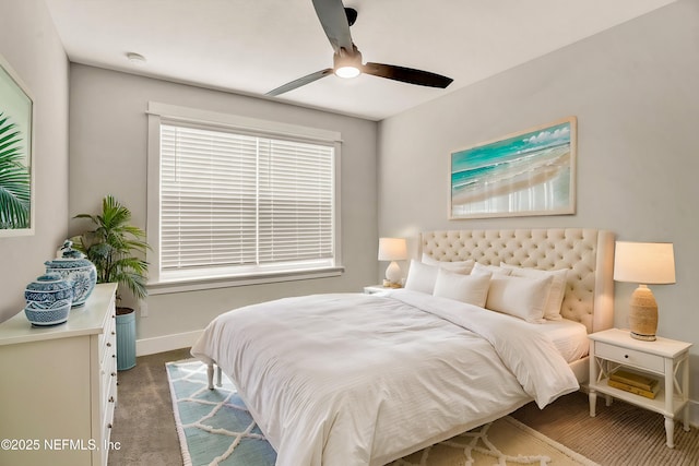 bedroom featuring ceiling fan and dark colored carpet