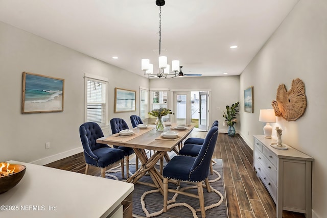 dining space featuring dark hardwood / wood-style flooring and an inviting chandelier