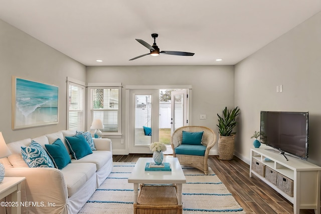 living room with dark hardwood / wood-style floors and ceiling fan