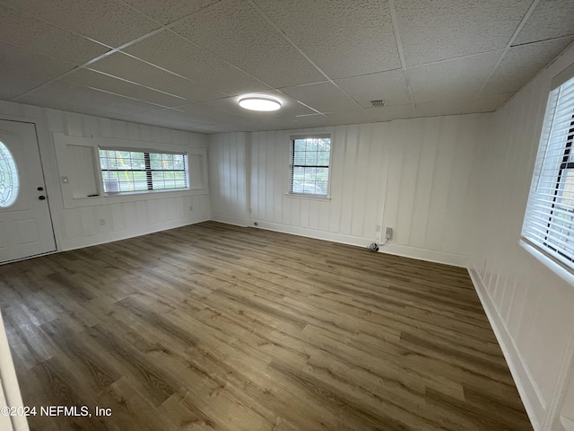 interior space featuring wood-type flooring and a paneled ceiling