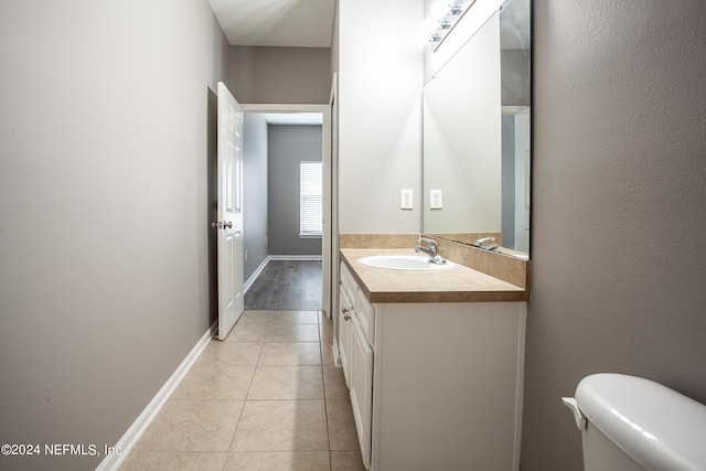 bathroom featuring tile patterned floors, vanity, and toilet