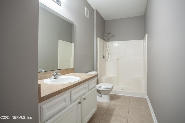 bathroom featuring tile patterned floors, vanity, walk in shower, and toilet