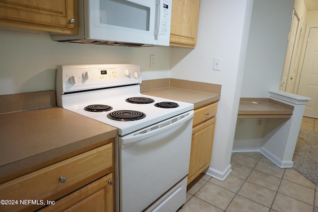 kitchen with white appliances, light tile patterned flooring, and baseboards