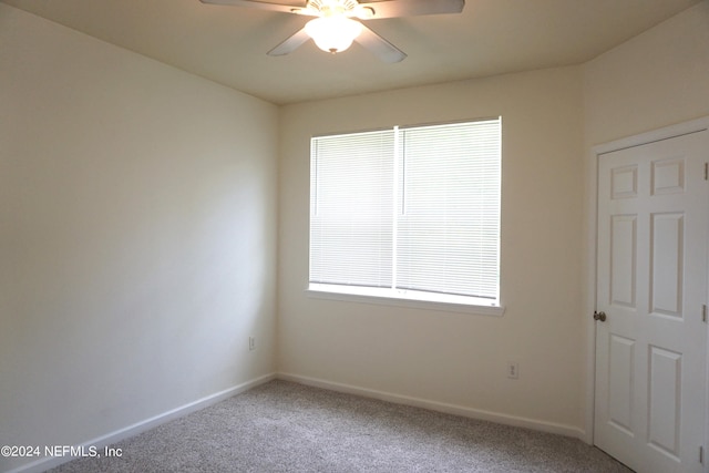 spare room with ceiling fan, baseboards, and carpet flooring