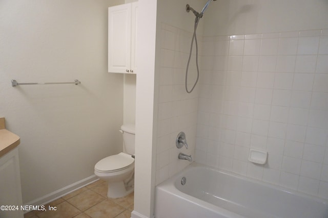 bathroom featuring toilet, vanity, shower / tub combination, tile patterned flooring, and baseboards