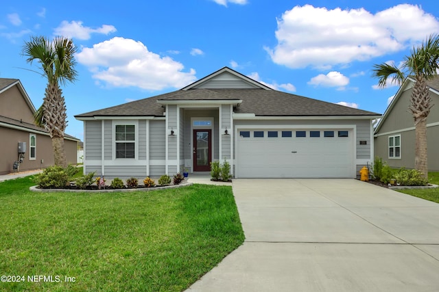 view of front of property with a garage and a front lawn